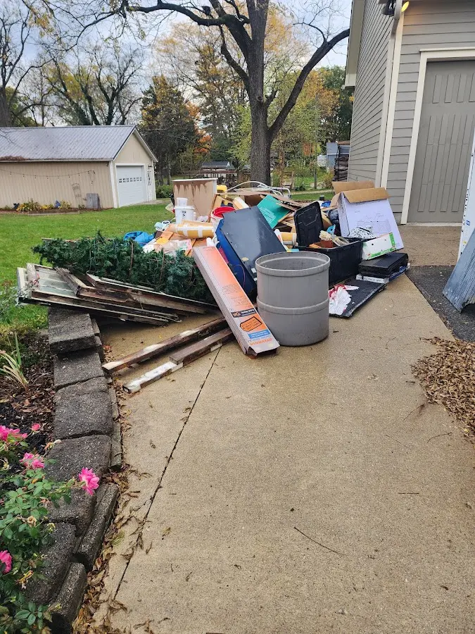 Dumpster being loaded with debris for Commercial Dumpster Rental in West Orange